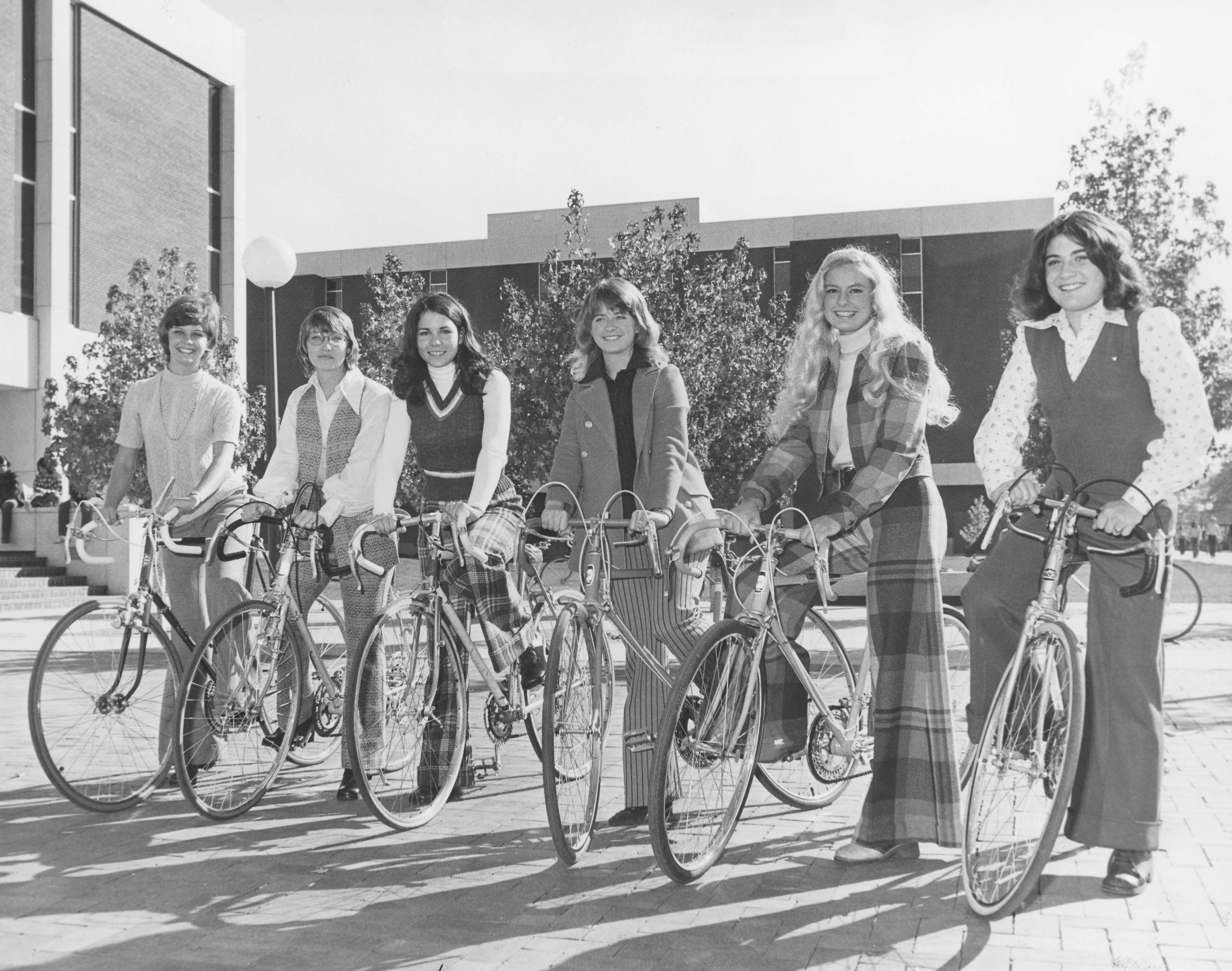 Beauty Pageant Contestants on bicycles